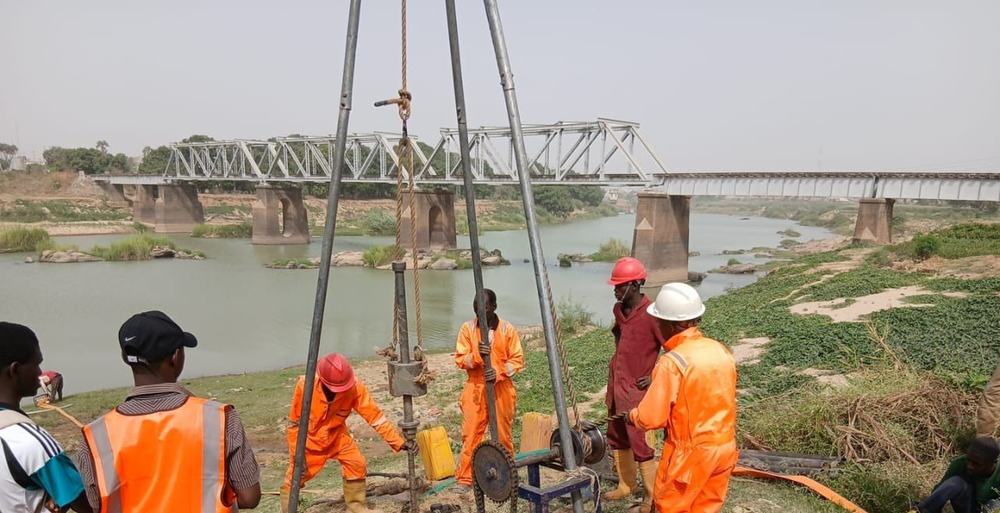 Cable percussion boring beside a river bridge during a geotechnical investigation